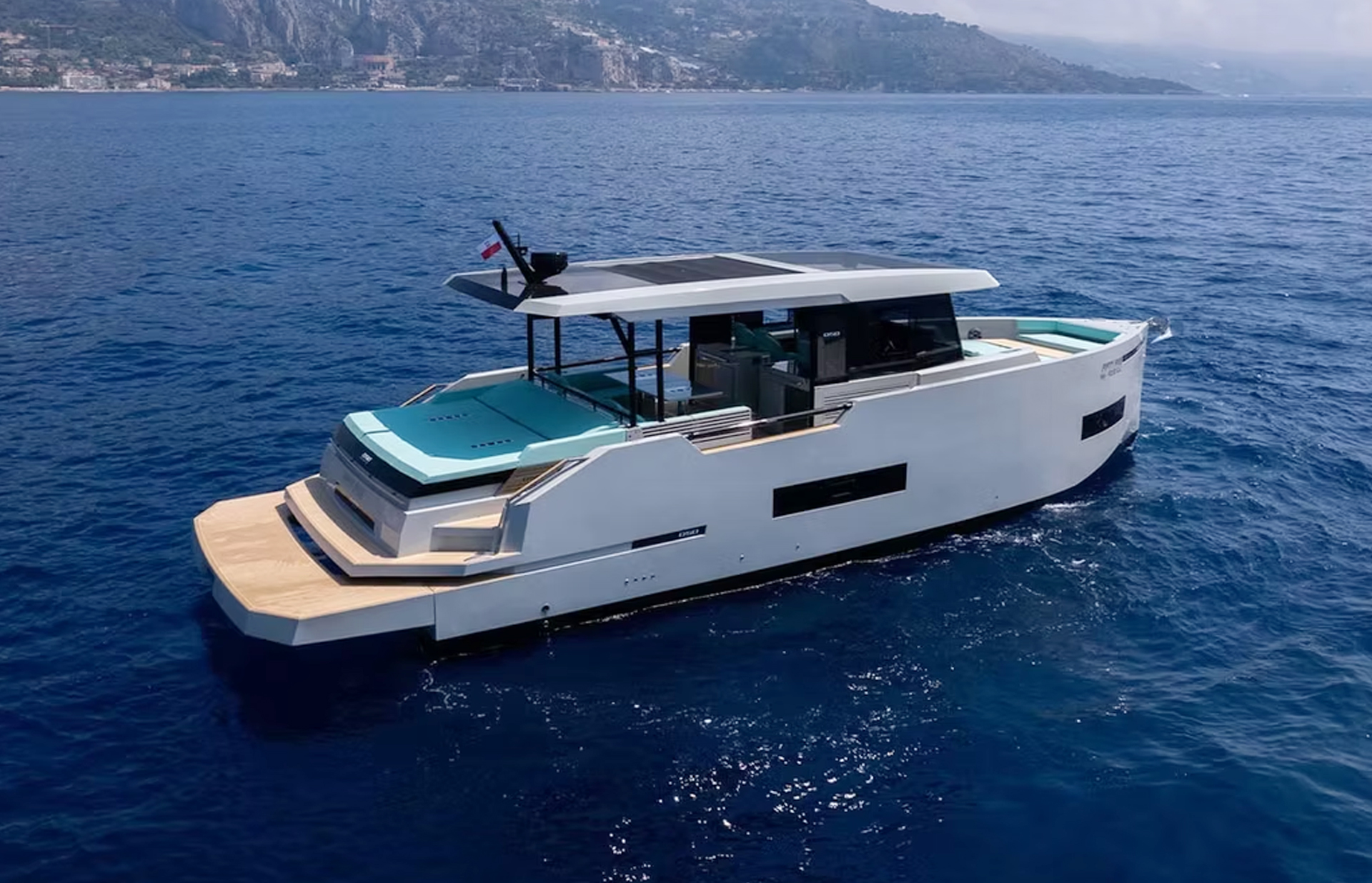 Side profile of the De Antonio D50 Coupé cruising along the coast