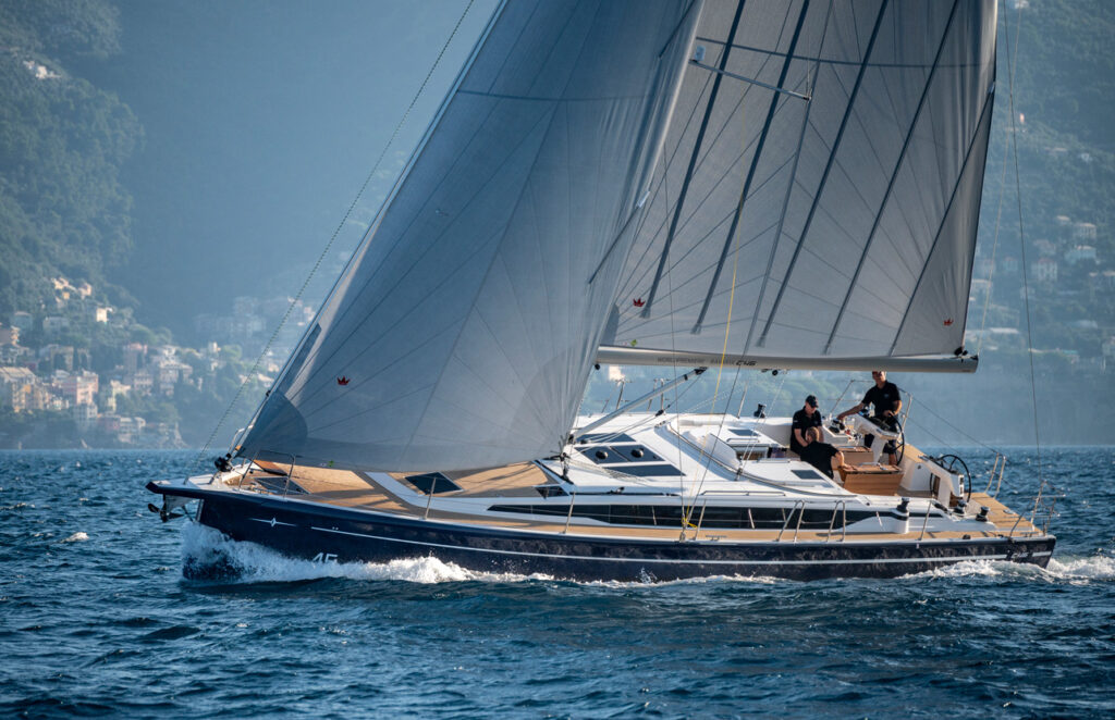 Bavaria C46 sailing yacht cruising under sail along the coast