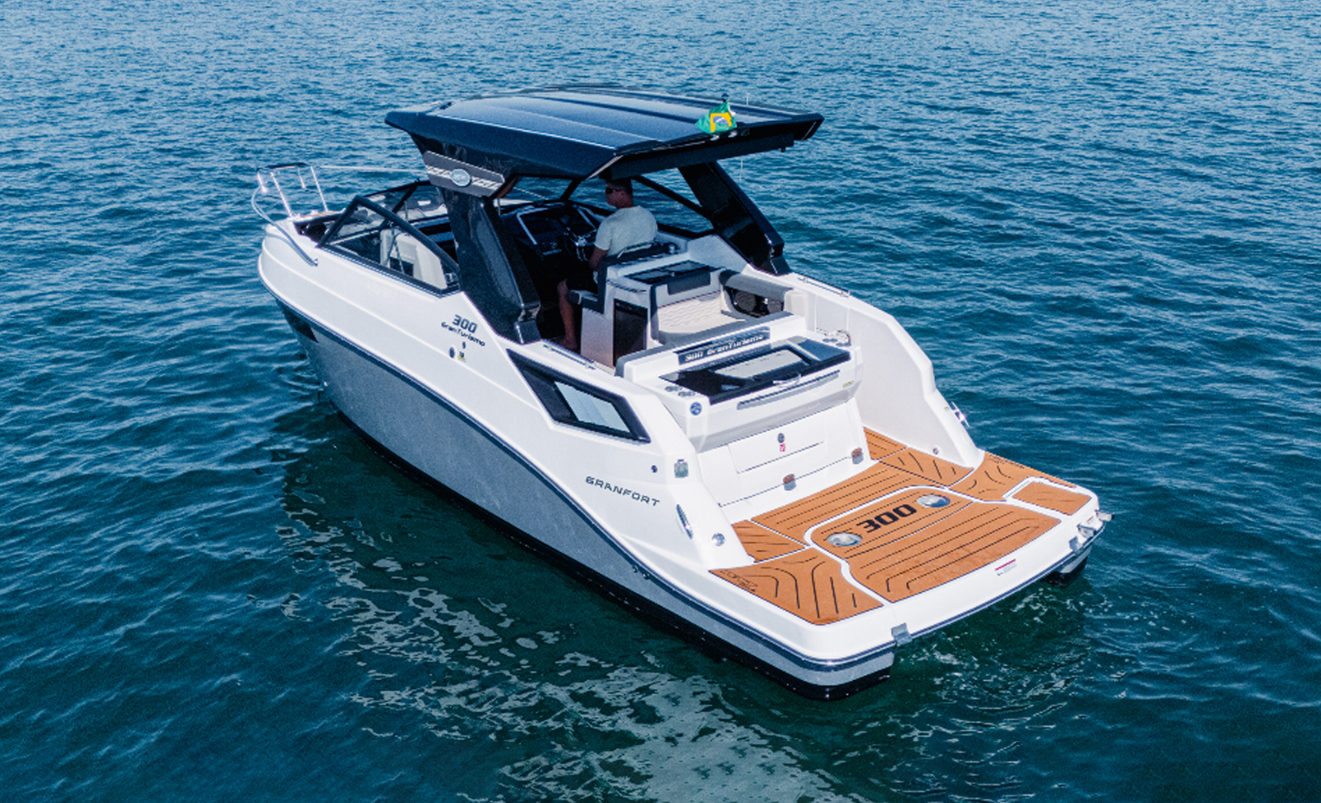 Elevated rear view of the Granfort 300 GTS showing the swim platform, cockpit and black hardtop
