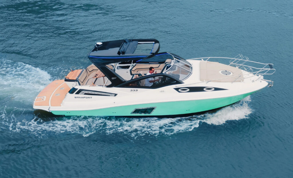 Side view of the Granfort 333 GTO sport cruiser with white hull and black T-Top cruising across the water