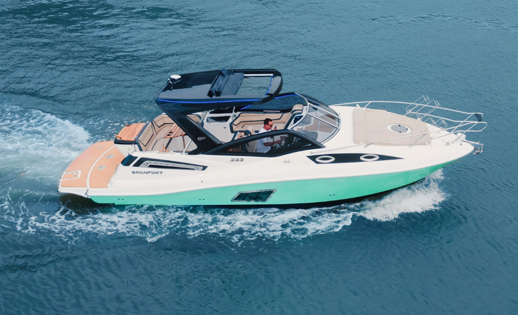 Side view of the Granfort 333 GTO sport cruiser with white hull and black T-Top cruising across the water