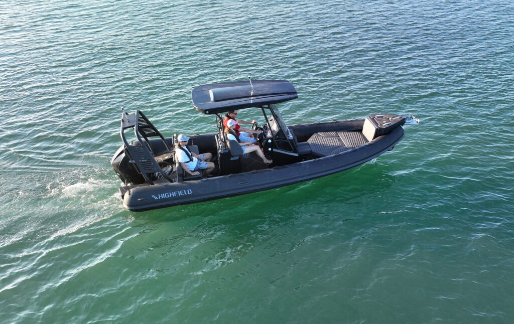 Side view of Highfield SP700 Sport RIB cruising with passengers on board