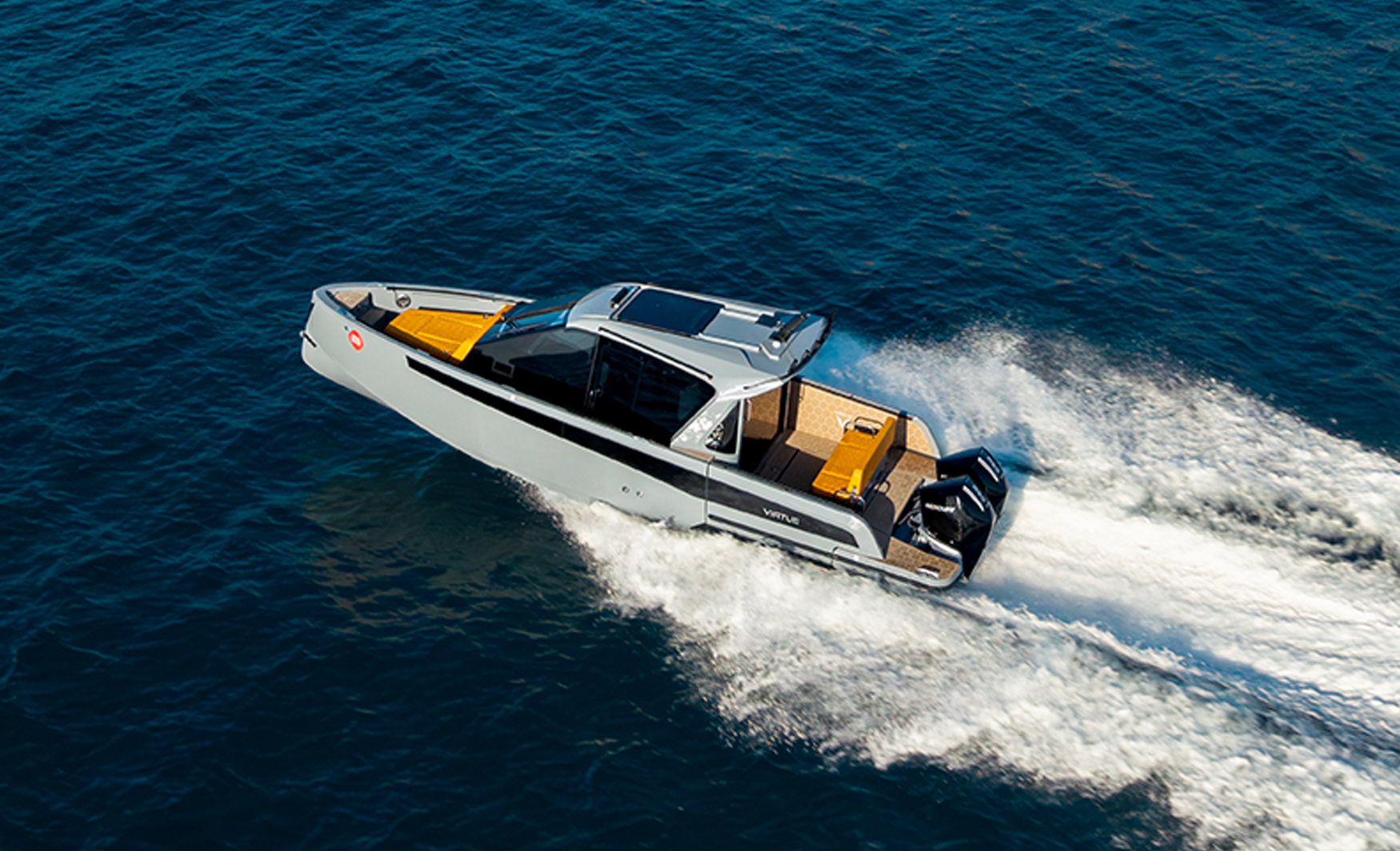 Aerial view of the Virtue V33 Cabin underway, highlighting its distinctive roof design and streamlined hull.