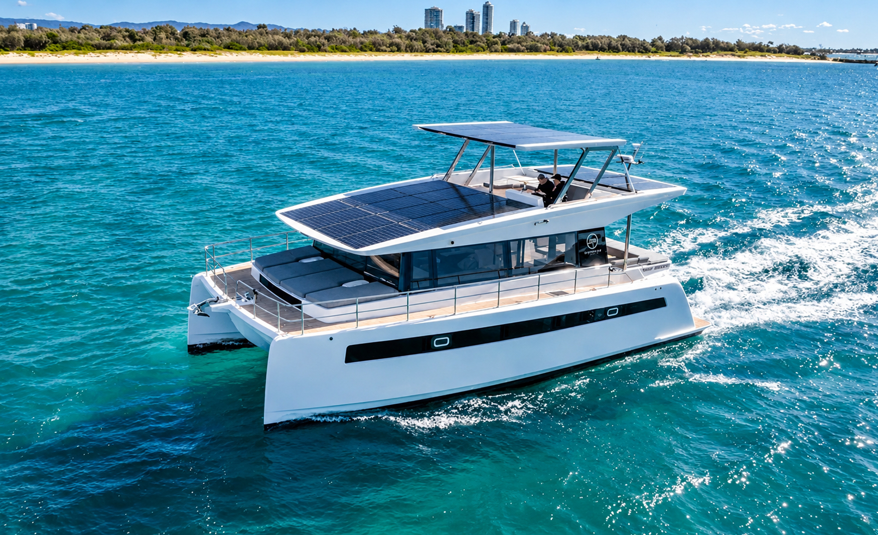 Aerial view of the Sunpower Solar-E 44 Charter cruising through turquoise waters, showcasing its solar-panel roof, flybridge and twin-hull design.